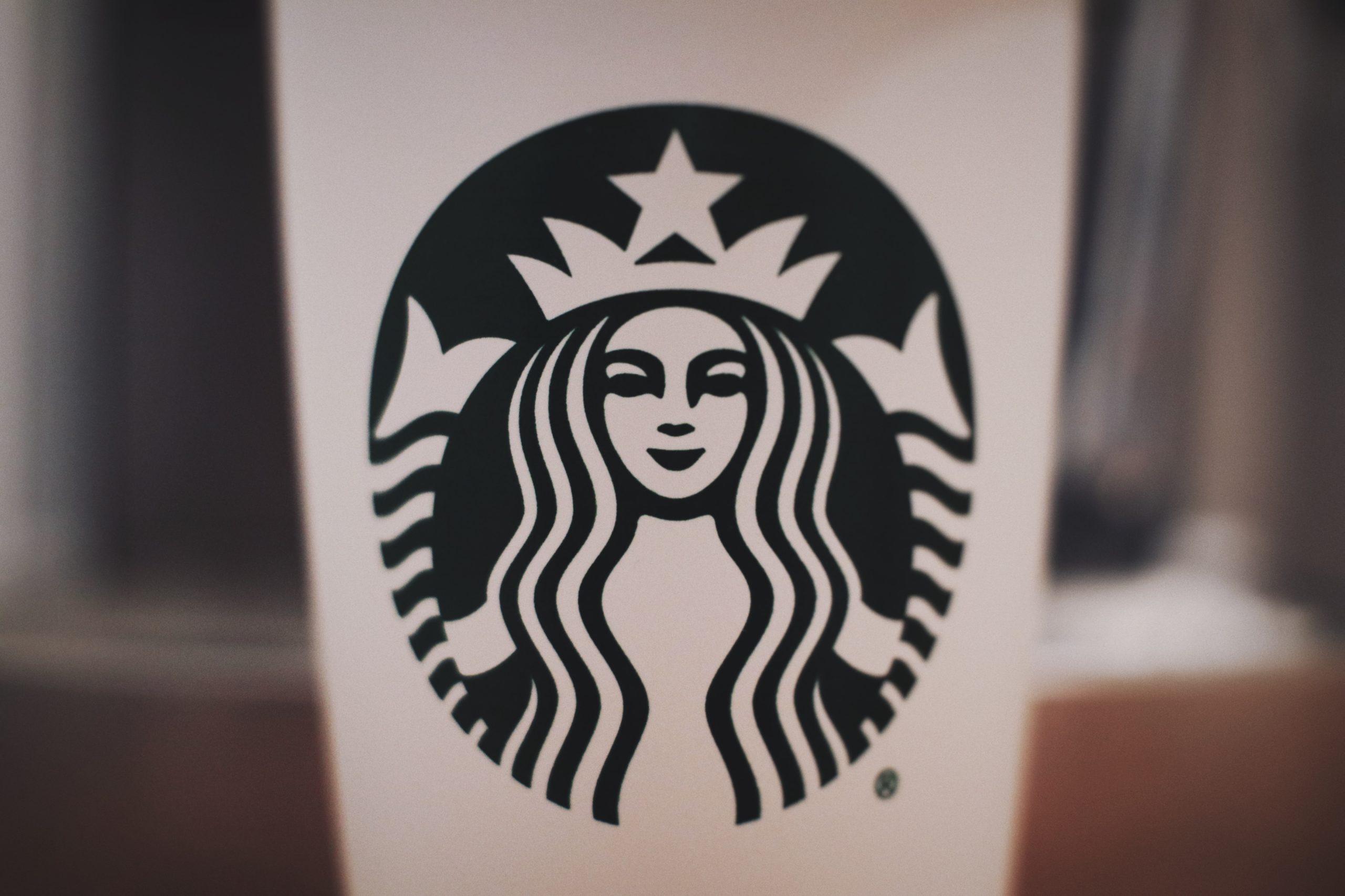 Starbucks logo on a white coffee cup